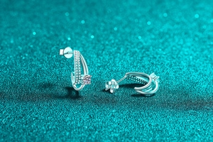 Macro detail of S925 sterling silver moissanite earrings with double curve pave setting