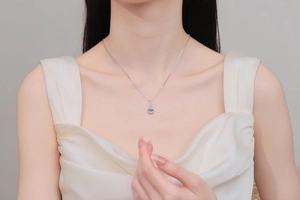 Detailed view of an S925 sterling silver water drop pendant with a light blue moissanite stone
