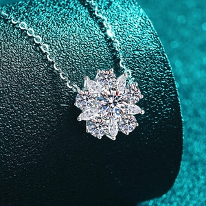 S925 sterling silver sunflower pendant necklace with moissanite stones on green display