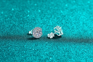 Macro shot of S925 silver moissanite stud earrings featuring halo setting and clear stones