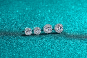 Macro shot of S925 sterling silver halo moissanite stud earrings in two different sizes