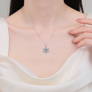 S925 sterling silver snowflake pendant necklace with moissanite on a female model