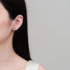 Elegant S925 sterling silver butterfly stud earrings with moissanite on model