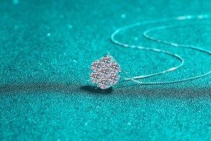 Macro view of S925 sterling silver sunflower pendant with sparkling moissanite cluster