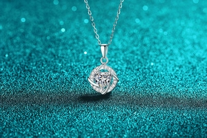 Macro view of sterling silver heart pendant necklace with moissanite and pave stones