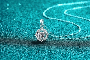 Detailed macro view of S925 silver heart swirl pendant with sparkling moissanite stone