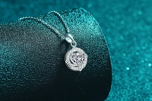 Macro shot of S925 sterling silver heart pendant with Moissanite stone and diamond accents