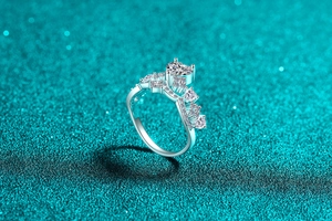 Macro shot of crown shaped S925 silver ring with heart cut moissanite and side stones