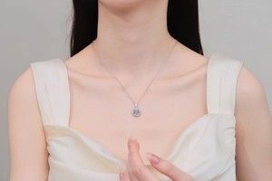 Close-up of S925 sterling silver heart swirl pendant necklace with moissanite on neck
