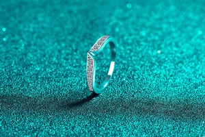 Detail macro view of S925 sterling silver V-shape ring with sparkling pavé moissanite stones