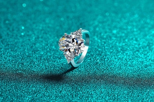 Macro shot of S925 silver ring with large oval moissanite and triangular side stones