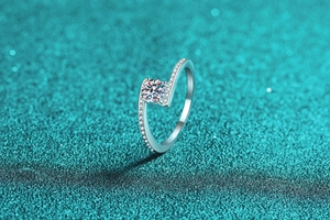 Macro shot of S925 sterling silver bypass ring with sparkling moissanite center stone