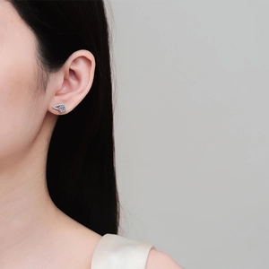 Elegant S925 sterling silver V-shaped moissanite stud earrings on female model's ear