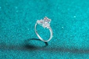 Macro view of S925 silver ring featuring a heart-shaped moissanite and floral accents