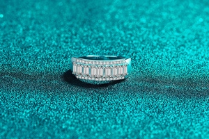 Macro shot of S925 silver baguette-cut moissanite band with pavé micro-diamonds