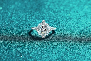 Close-up of S925 sterling silver moissanite ring with oval center stone and petal halo