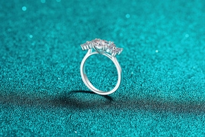Detail of S925 sterling silver ring with five round moissanite stones in a prong setting