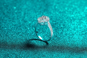 Macro detail of S925 sterling silver moissanite ring with flower halo setting and pavé diamonds