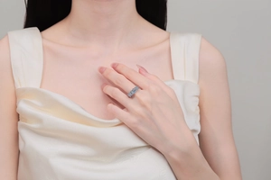 Classic S925 sterling silver moissanite ring elegantly worn by a model in satin dress