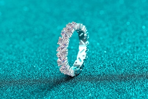 Macro shot of silver eternity ring with alternating round and baguette cut moissanite