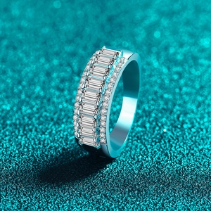 Sparkling S925 sterling silver baguette cut moissanite ring on teal glitter background