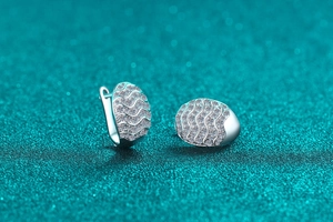 Macro shot of silver wave-patterned hoop earrings with micro-pave moissanite stones