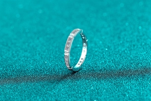 Macro shot of silver bamboo style moissanite ring with row of pave set gems