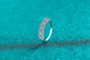 Macro view of seven oval-cut moissanite stones in a sterling silver prong setting
