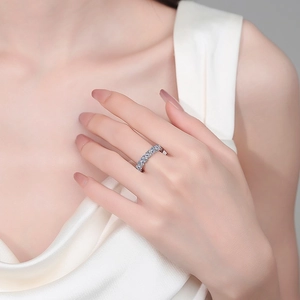 Elegance of S925 sterling silver moissanite eternity ring on model hand with silk fabric