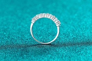 Side view detail of S925 sterling silver ring with oval moissanite shared prong setting