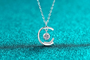 Macro shot of S925 sterling silver C-shaped pendant with brilliant moissanite center stone