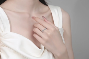 Close-up of minimalist S925 sterling silver moissanite ring worn on female hand