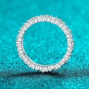Polished S925 sterling silver eternity ring featuring full moissanite stones on blue background