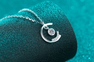 Macro shot of S925 sterling silver moissanite pendant with sparkling round center stone