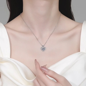 Elegant heart-shaped 925 sterling silver moissanite pendant necklace worn by a model