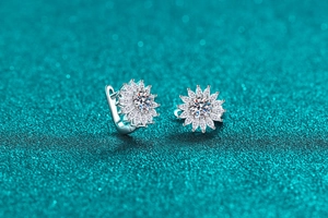 Macro detail of silver maple leaf earrings with sparkling moissanite stones