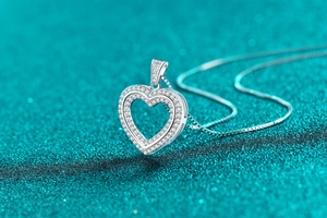 Macro detail of S925 sterling silver heart pendant with shimmering moissanite stones