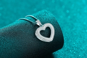 Detailed view of S925 sterling silver double heart necklace with sparkling zircon pavé