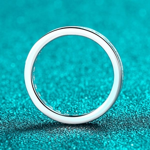 Polished S925 sterling silver moissanite ring with side channel setting on blue background