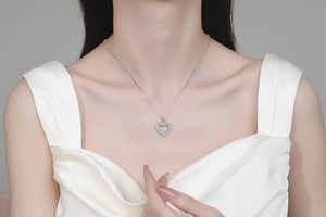 Detail of S925 sterling silver double heart necklace with pavé moissanite on model