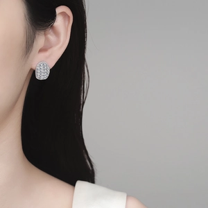 Sparkling S925 sterling silver moissanite wave earrings worn by a model in close-up shot