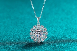 Macro detail of sunflower pendant with moissanite center stone on delicate silver chain