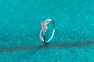 Macro detail of S925 silver ring with triple moissanite stones and pavé accents