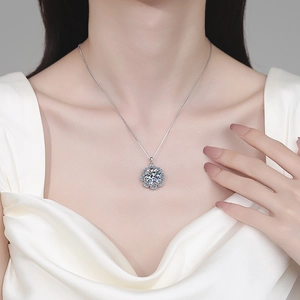 Elegant S925 sterling silver sunflower moissanite necklace displayed on a silk background
