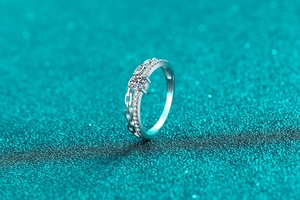 Macro detail of S925 sterling silver ring with moissanite center stone and chain band