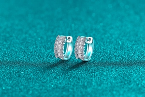 Macro detail of S925 sterling silver hoop earrings with triple-row moissanite stones