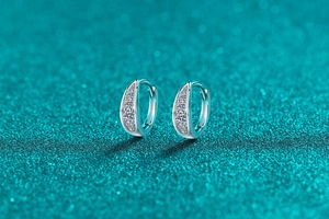 Macro view of S925 sterling silver moissanite hoop earrings with leaf-shaped stone setting