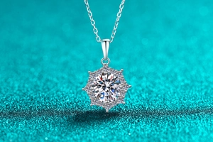 Macro shot of snowflake moissanite pendant with sterling silver chain on blue background