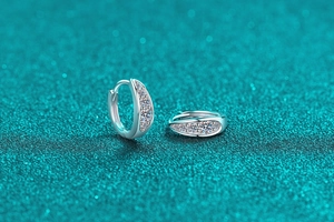 Macro shot of 925 silver hoop earrings with clear round moissanite stones
