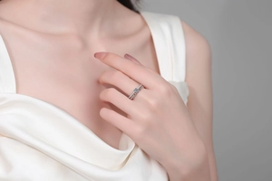 Detail of s925 silver double-layer ring with blue moissanite on white silk dress